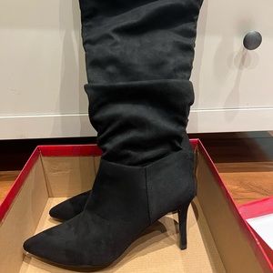 Knee-high black stiletto heeled boots